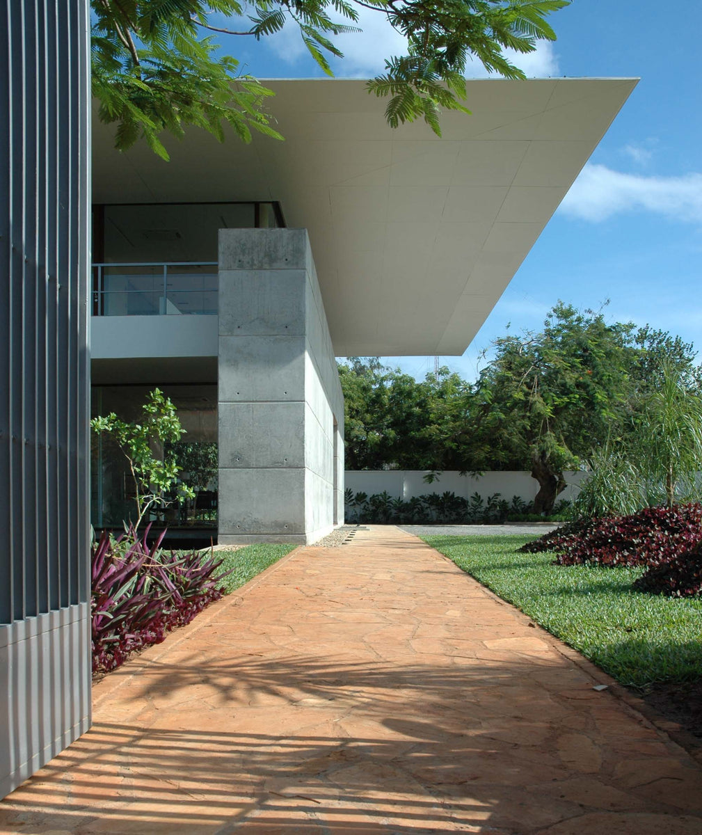 AON offices in Dar es Salaam, thin white canopy cantilevering over a concrete wall and garden path