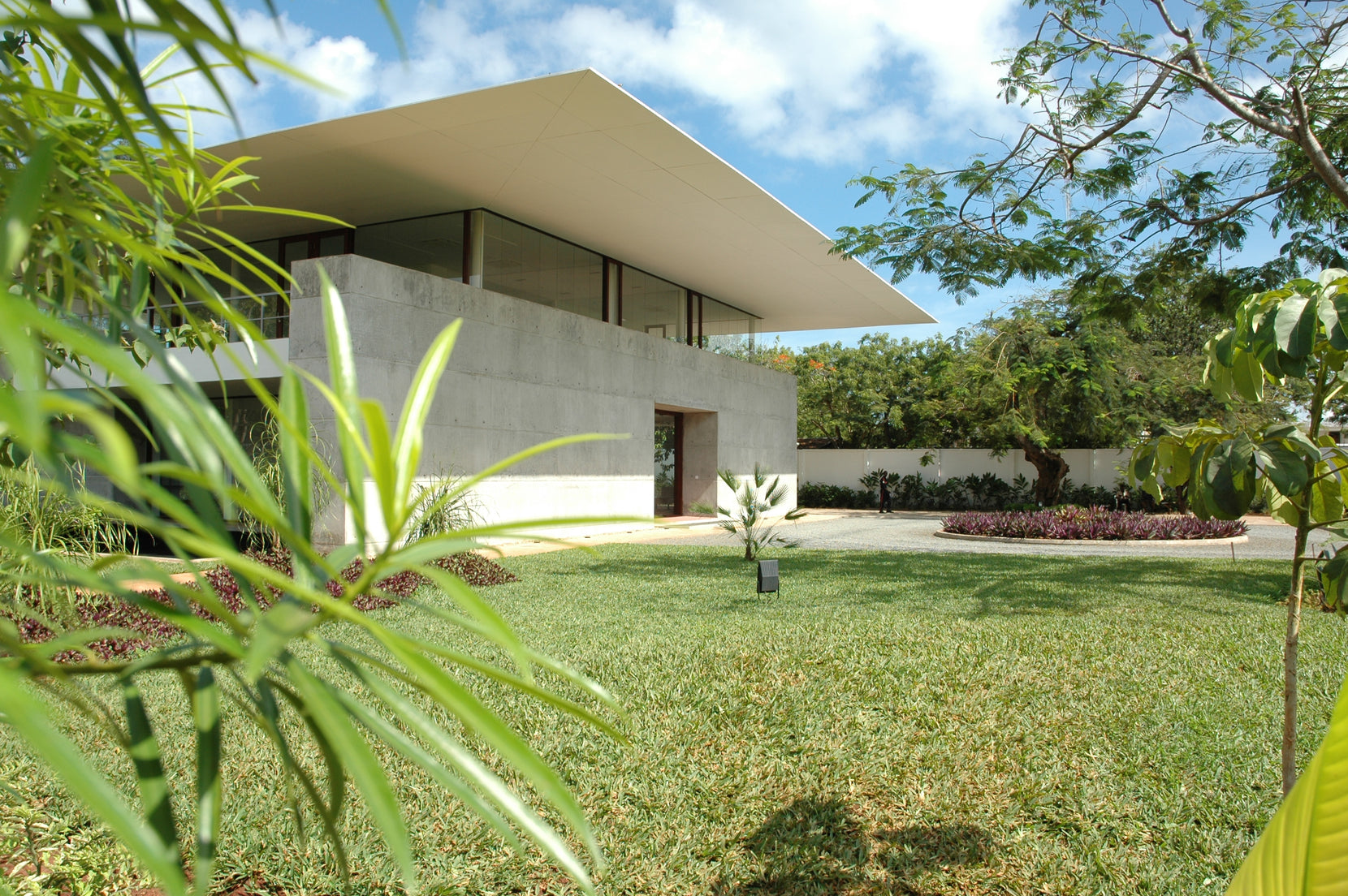 Blade roof floating above the concrete cabinets of the AON building, seen across the lawn
