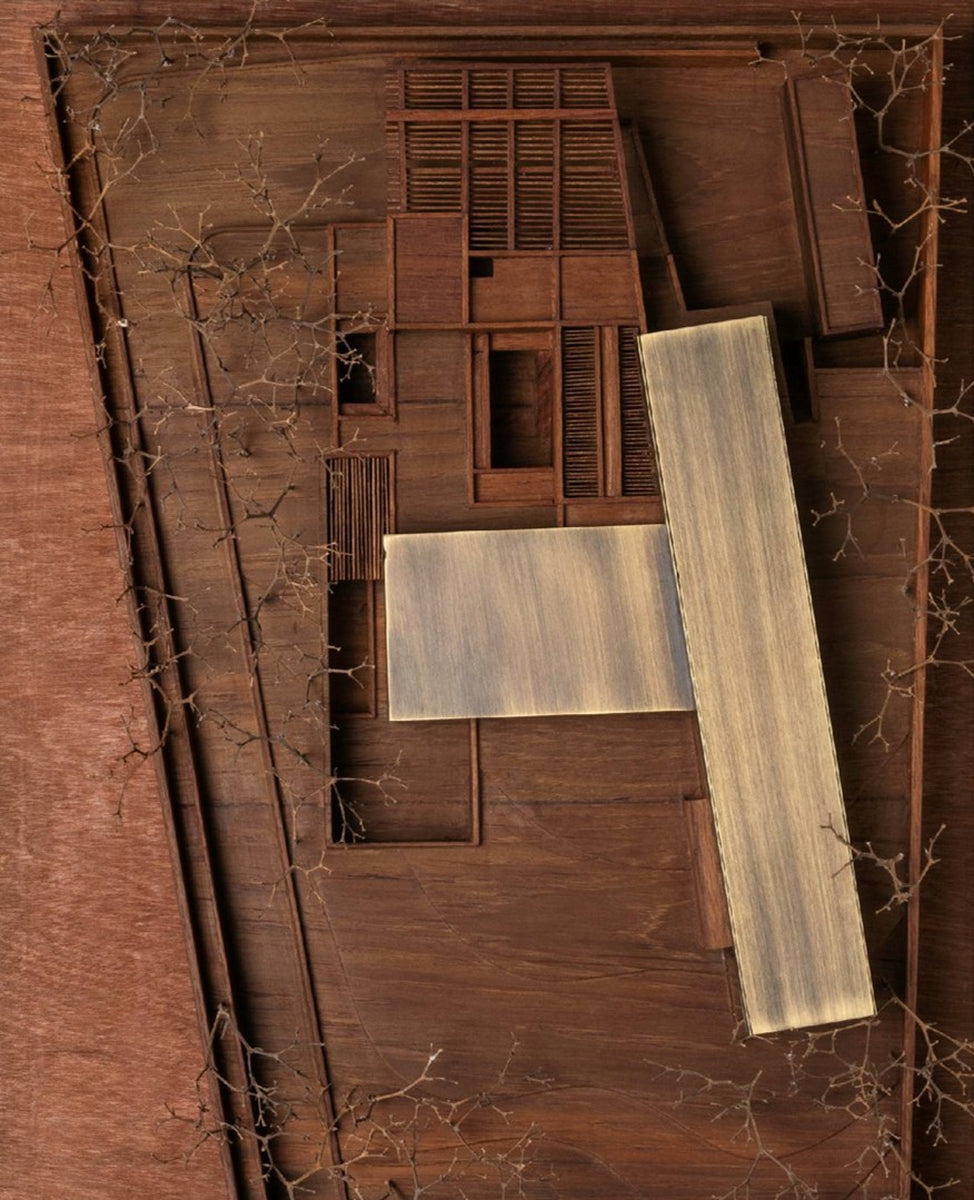 Scale model of Copper House from directly above, brass roof planes over timber courtyards