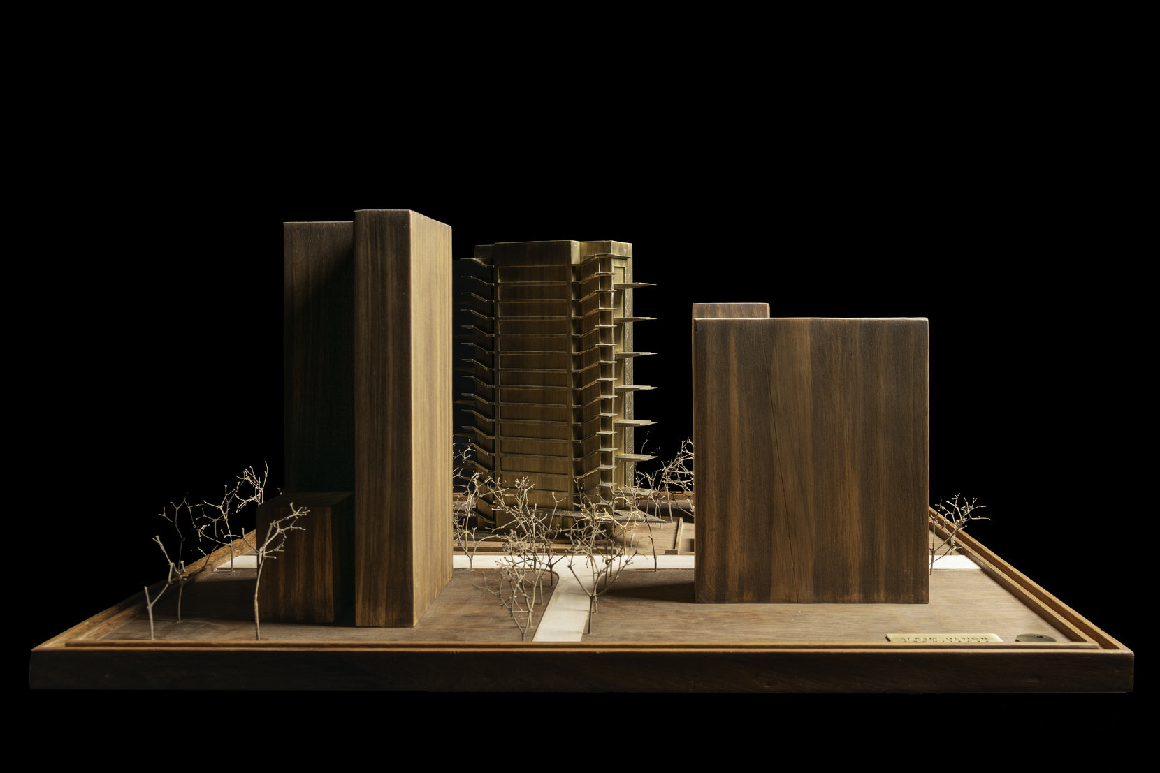 Scale model of the whole site, the brass tower set between solid timber neighbours