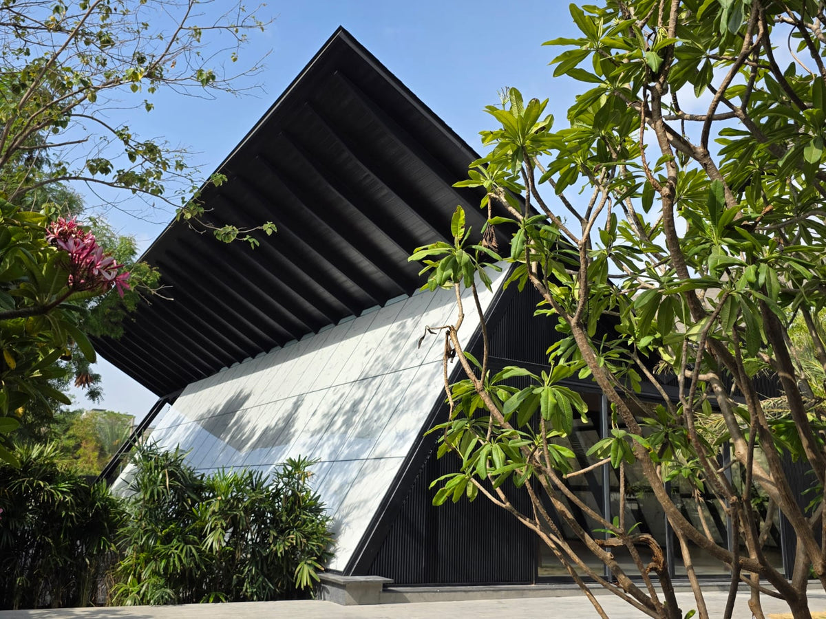 GAIA in Ahmedabad, its folded black roof lifting over marbled glass walls
