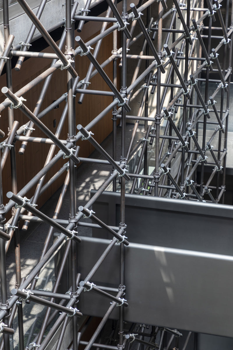 Diagonal bracing of the tube screen crossing over a steel bridge in the atrium