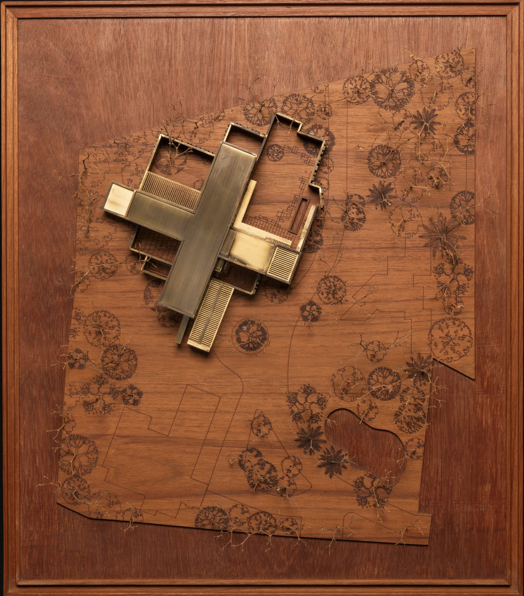 Scale model of the cruciform plan in brass, on a board etched with the site's existing trees