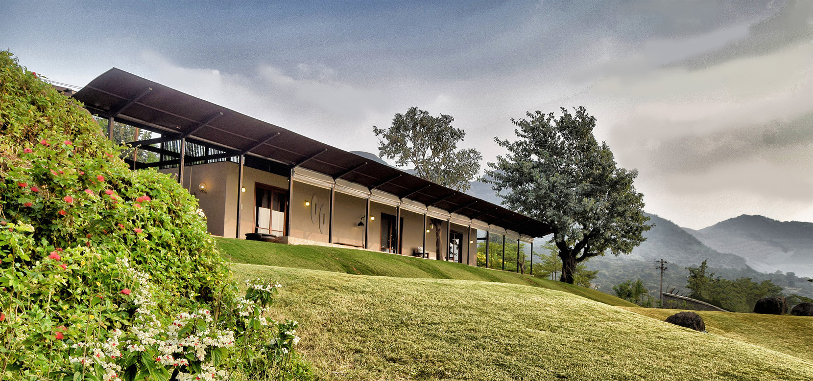 Verandah colonnade along the grassy slope, hills of the Western Ghats to the right