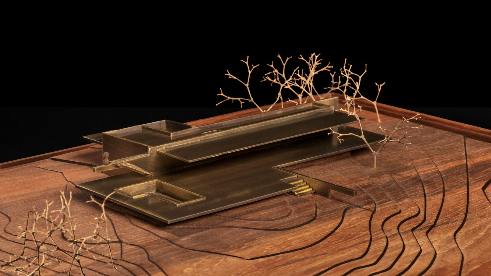 Scale model in brass on a contoured timber base, wire trees marking the site planting