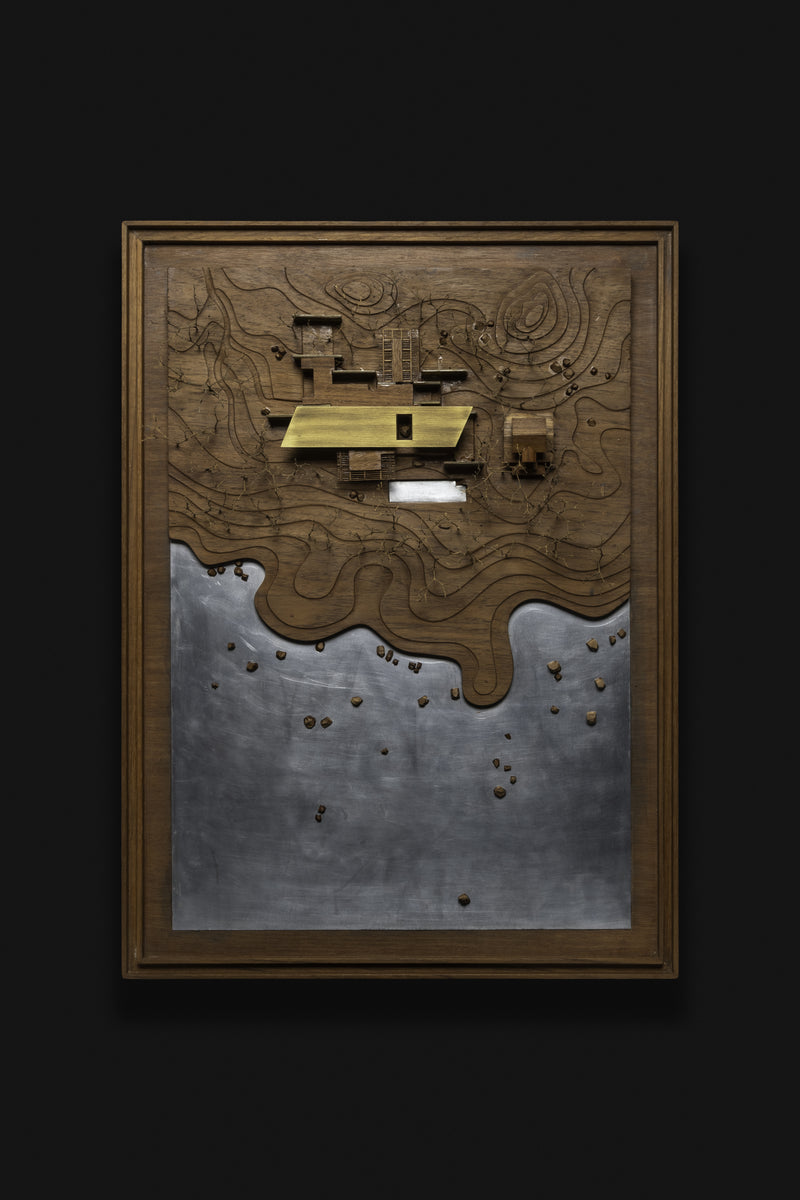 Framed physical model head-on, the plan read against contour lines and the shoreline