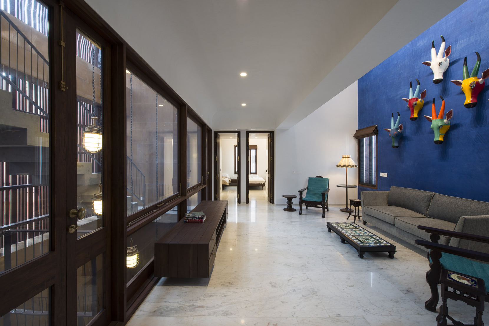 Upper living space with painted animal heads on a blue wall and glazing onto the light shaft