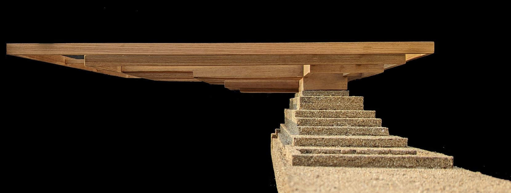 Study model in profile, flat timber roof cantilevering over the stepped sand-coloured plinth