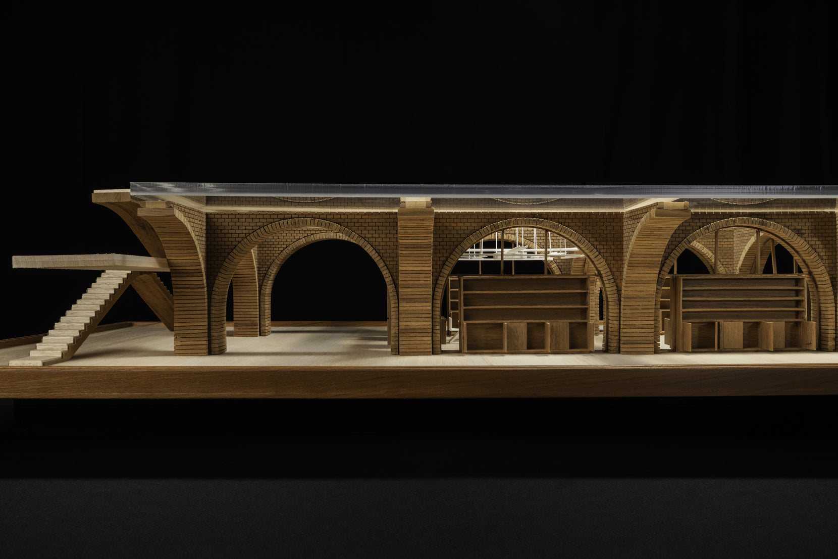 Scale study model in side elevation, showing the arched brick base under a glazed roof