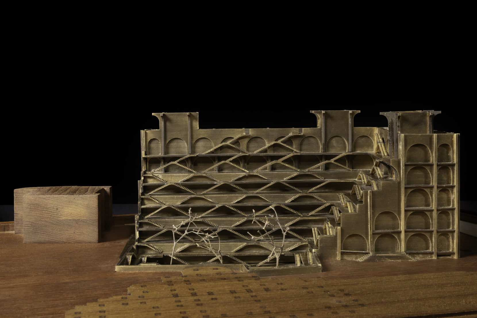 Physical study model of the criss-cross stair lattice, a plain timber block set alongside