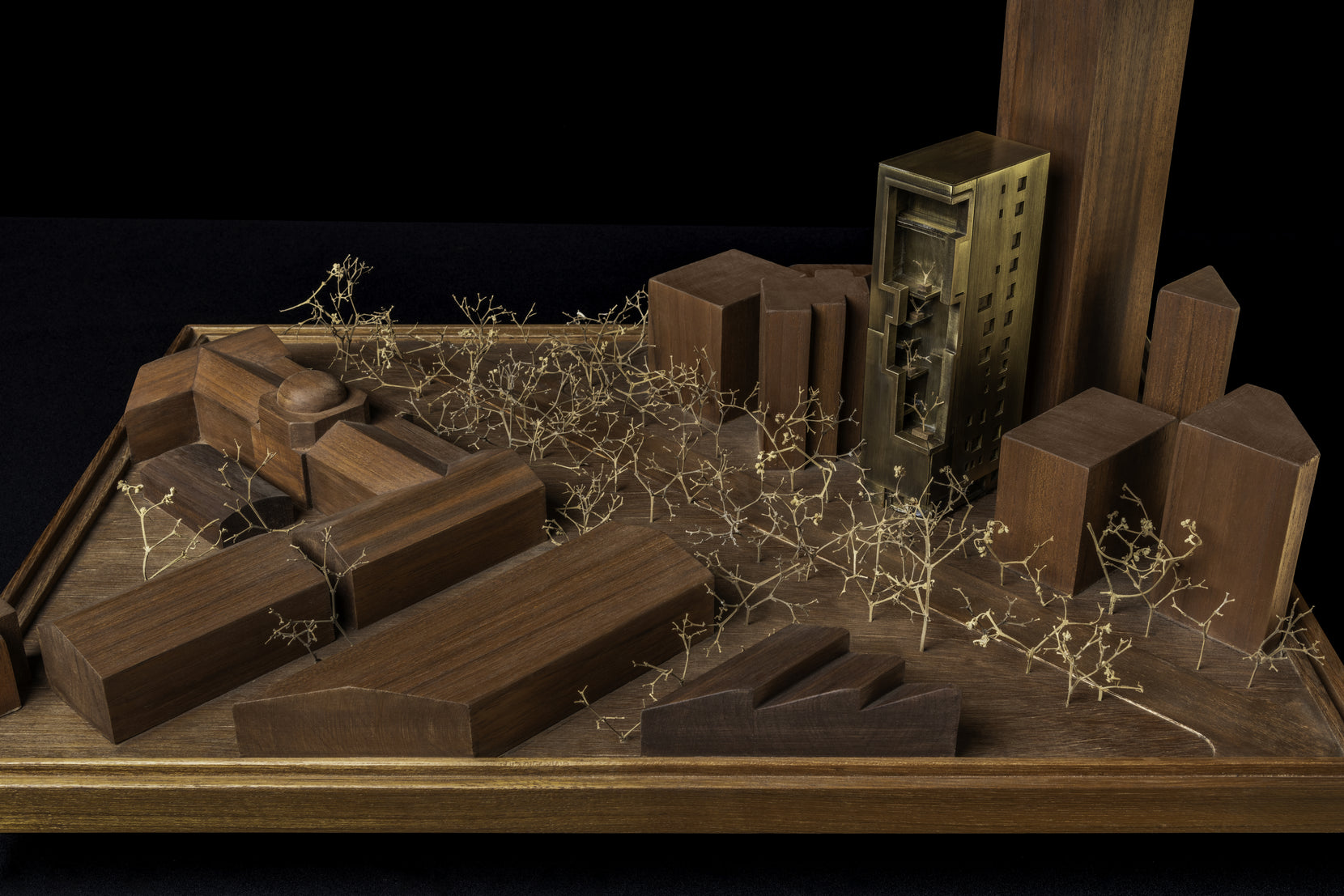 Physical study model of the site, neighbouring blocks in dark timber with the tower cast in brass